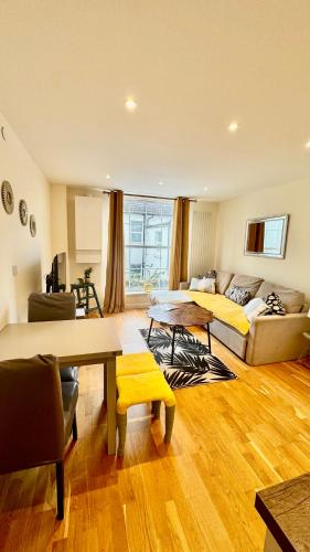 a living room with a bed and a couch at St Leonards Boutique Apartment in Hollington