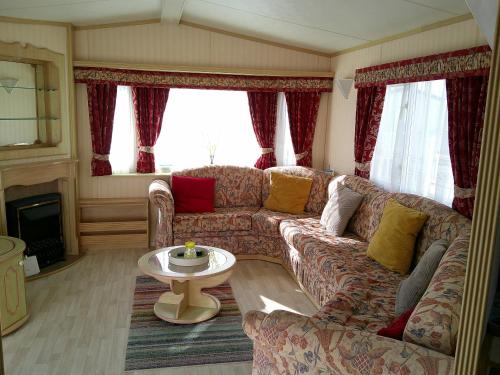a living room with a couch and a table at Golden Sands Willerby GS 6 Berth Panel heated FREE WIFI in Ingoldmells