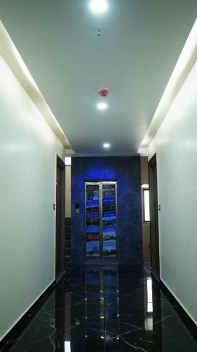 a hallway in a building with a blue wall at Hotel Kailash Inn in Garudeshwar