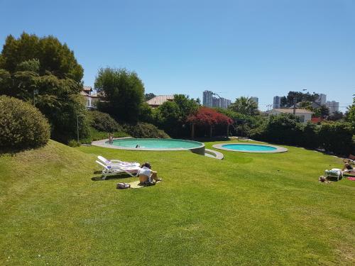 a group of people in a park with two pools at Departamento ideal para relajarse y descansar in Concón