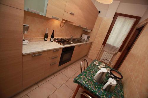 a kitchen with wooden cabinets and a counter top at Apartment in Rosolina Mare 3 in Rosolina Mare