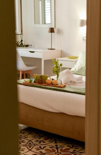 a bedroom with a bed with a tray of fruit on it at Madre Terra Airport Apartment & Rooms in Terrasini