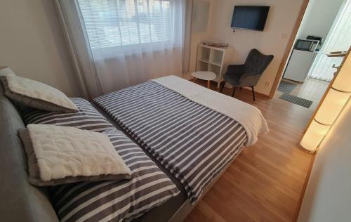 a small bedroom with two beds and a chair at Privat Inn in Rakvice