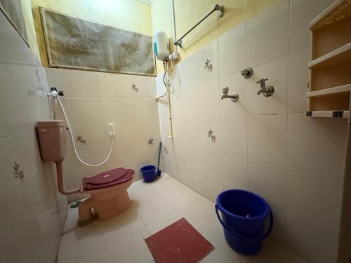 a bathroom with a toilet and a shower at Kanasu guest house in Gokarna