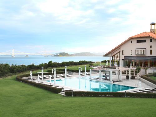 an aerial view of a house with a pool and the golden gate bridge at Hotel Anaga in Minamiawaji