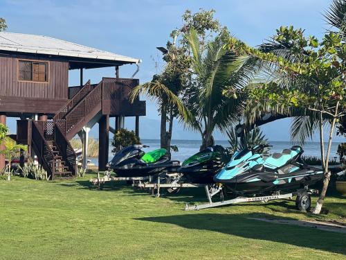a group of boats are parked next to a house at Bahía Caimán , Río dulce in Rio Dulce