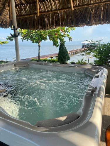 a jacuzzi tub with the ocean in the background at Bahía Caimán , Río dulce in Rio Dulce