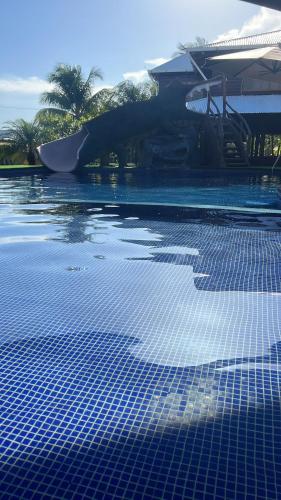 a swimming pool with blue tiles on top of it at Bahía Caimán , Río dulce in Rio Dulce