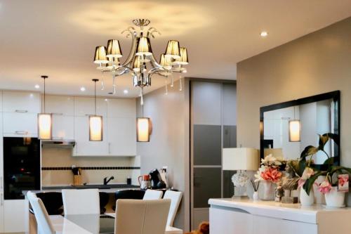 une salle à manger et une cuisine avec un lustre dans l'établissement L'Escale des Rimains avec vue sur mer exceptionnelle, à Cancale