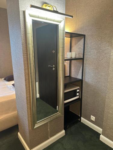a bathroom with a mirror next to a bed at President Apartments by WarsawResidence Group in Warsaw