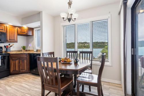 a kitchen and dining room with a table and chairs at Moor Fun in Kimberling City