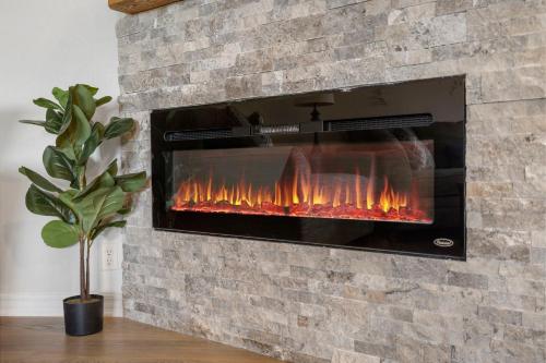 a brick fireplace with a fire in it at Moor Fun in Kimberling City