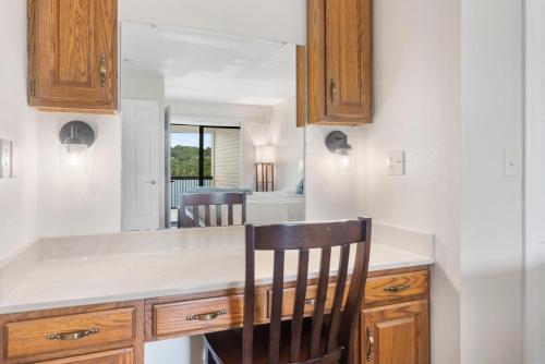 a kitchen with a counter and a mirror at Moor Fun in Kimberling City