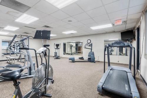 a gym with several tread machines in a room at Moor Fun in Kimberling City