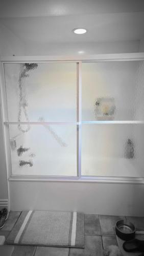 a glass window in a room with a floor at Beautiful Kentucky Derby Rental Home Accommodating 10 Guests or More in Louisville
