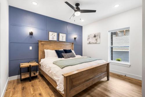 a bedroom with a blue accent wall and a bed at Over the Top in Hollister