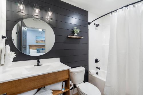 a bathroom with a white sink and a mirror at Over the Top in Hollister
