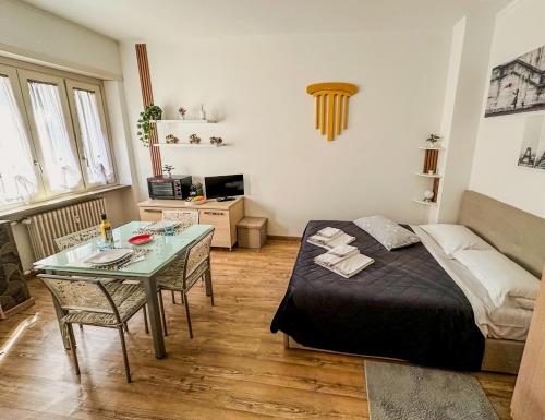 a bedroom with a bed and a glass table at Smart Studio - Lingotto, Fiera & Metro in Turin