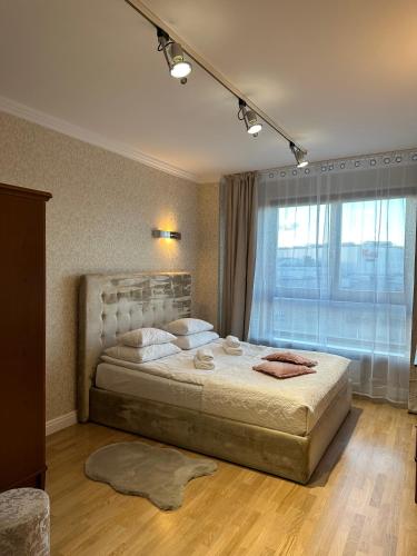 a bedroom with a large bed and a large window at President Apartments by WarsawResidence Group in Warsaw
