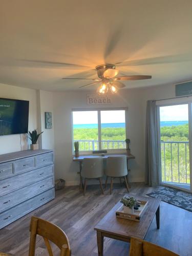 a living room with a ceiling fan and a table at Ocean Pointe Resorts - Serenity 2308 in Tavernier