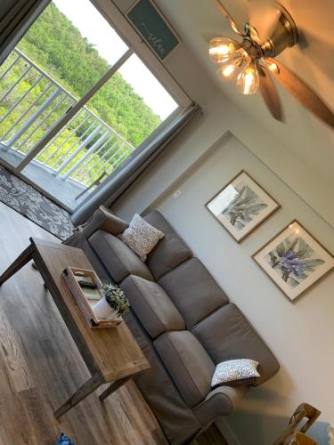 a living room with a couch and a large window at Ocean Pointe Resorts - Serenity 2308 in Tavernier