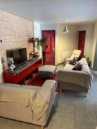 un salon avec deux canapés et une télévision dans l'établissement appartement spacieux avec piscine à 15 minutes d'Hossegor, à Saint-Vincent-de-Tyrosse