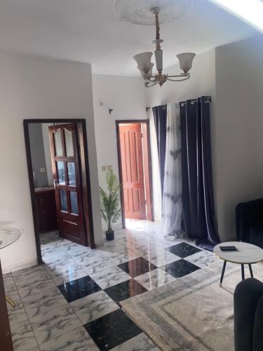 a living room with a door and a floor at FLORILÈGEHome in Yaoundé