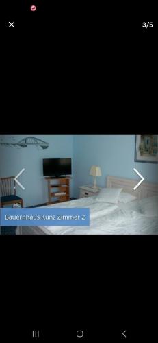 a picture of a bedroom with a bed and a television at Fehmarn Bauernhauskunz in Fehmarn