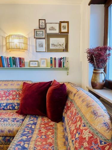 a couch with two pillows sitting in a living room at Apartment in South Tyrol with a beautiful panoramic view in Verano