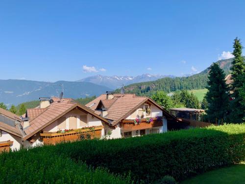 a house on a hill with mountains in the background at Apartment in South Tyrol with a beautiful panoramic view in Verano