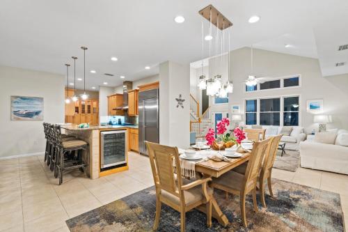 a dining room and living room with a table and chairs at The Sun Dial - 827 in Siesta Key