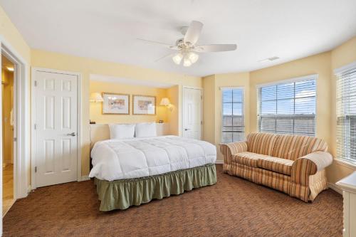 a bedroom with a bed and a couch and a chair at Lake Access Condo-Free Daily Tickets-Peaceful Views-Expansive in Kimberling City