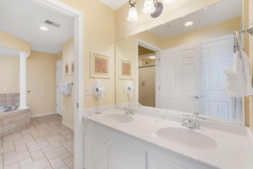 a bathroom with two sinks and a large mirror at Ozark Vista 129 in Kimberling City