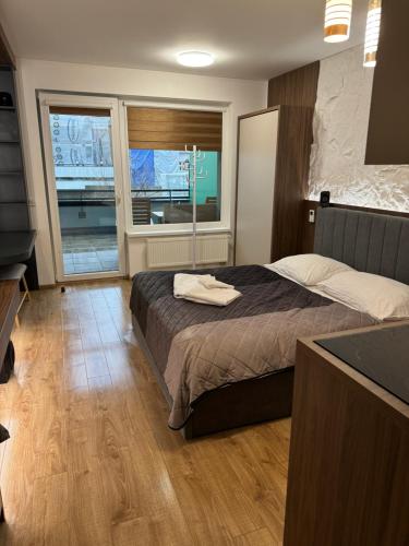 a bedroom with a bed and a large window at AH Luxury Radnica Spa in Košice