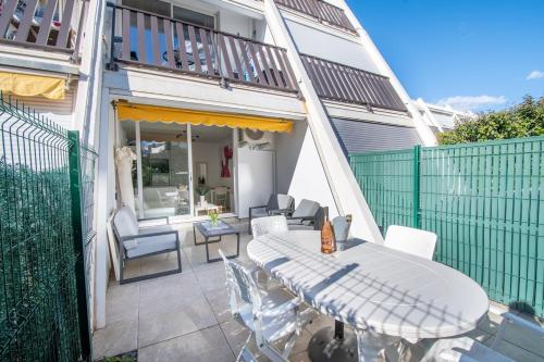 un patio avec une table et des chaises sur un balcon dans l'établissement Sable et Mediterranée, à La Grande Motte