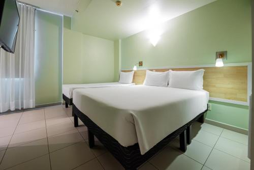 Ένα ή περισσότερα κρεβάτια σε δωμάτιο στο ibis Styles Manaus