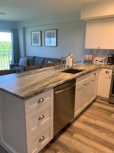 a kitchen with white cabinets and a counter top at Ocean Pointe Resorts - Serenity 2308 in Tavernier