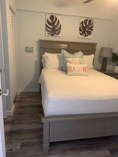 a bedroom with a large bed with asale sign on it at Ocean Pointe Resorts - Serenity 2308 in Tavernier