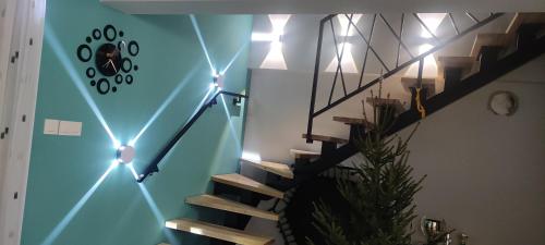 a staircase with lights in a room with a stair case at Biały domek z ogrodem, 3 sypialnie in Bydgoszcz