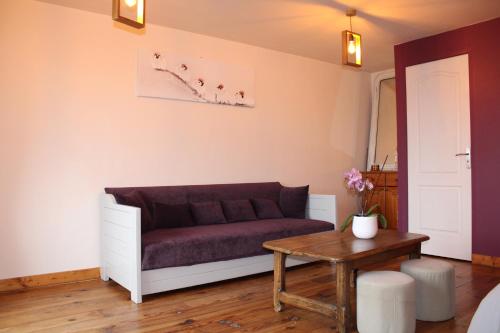 a living room with a couch and a table at La Bergerie du Plateau in Cros-de-Géorand