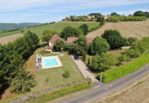- une vue aérienne sur une maison avec une piscine dans l'établissement Le Clos des Lilas, Gîtes de Charme, à Daglan