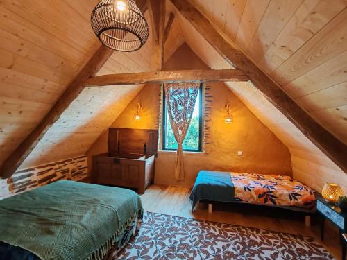 une chambre avec deux lits dans un grenier dans l'établissement ar wezenn gozh, à Laniscat