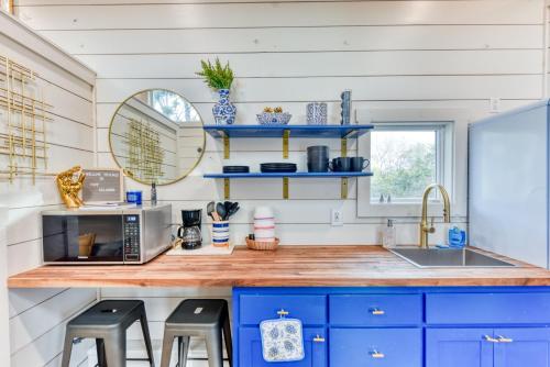 a kitchen with blue cabinets and a counter with a sink at Tiny Islands Resort in Blanco