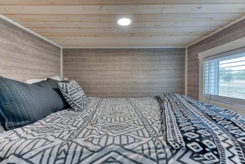 a bedroom with a bed with a comforter and a window at Tiny Islands Resort in Blanco