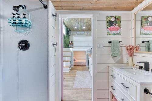 a kitchen with a door leading into a bathroom with a sink at Tiny Islands Resort in Blanco
