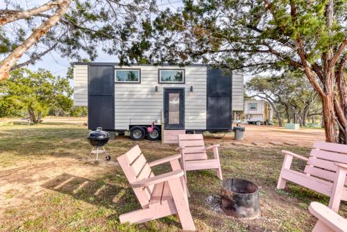 a tiny house with a grill and chairs at Tiny Islands Resort in Blanco
