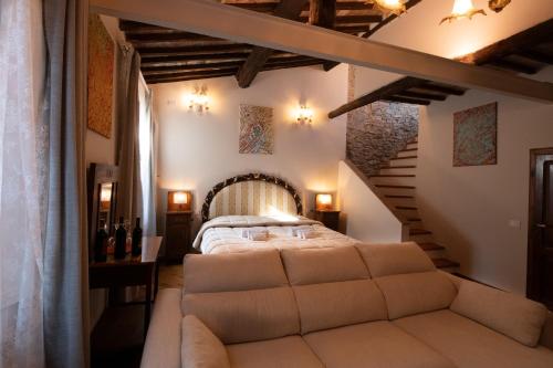 a bedroom with a bed in a room with stairs at IL PALAZZO DEL CARDINALE in Montalcino