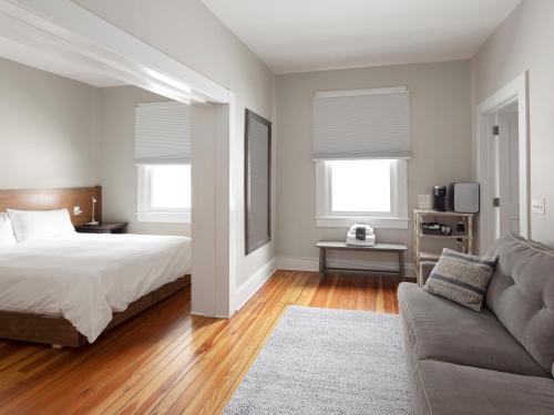 a bedroom with a bed and a couch at Lakehouse Inn in Lee