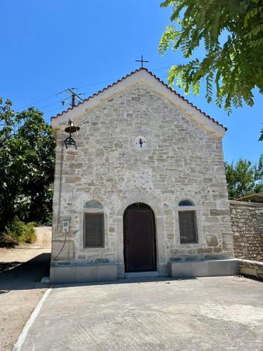 a small stone church with a black door at Beach Studio apartment 3, Komi in Chios
