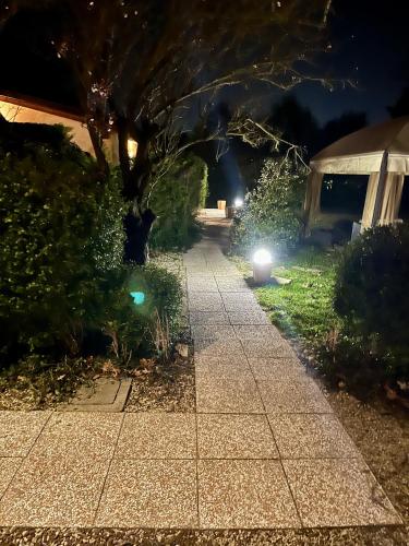 a walkway in a yard at night with lights at Country Home B&B Il Melo in Vicenza